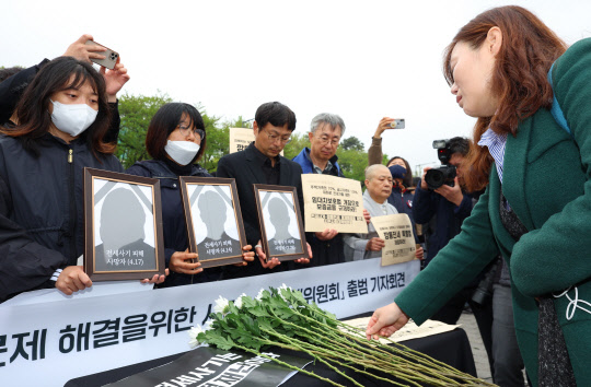 깊은 슬픔        18일 서울 용산구 대통령 집무실 앞에서 열린 전세사기·깡통전세 문제 해결을 위한 시민사회대책위원회 출범 기자회견에서 안상미(맨 오른쪽) 미추홀구 전세사기 피해자 대책위원장이 헌화하고 있다.      [연합뉴스]